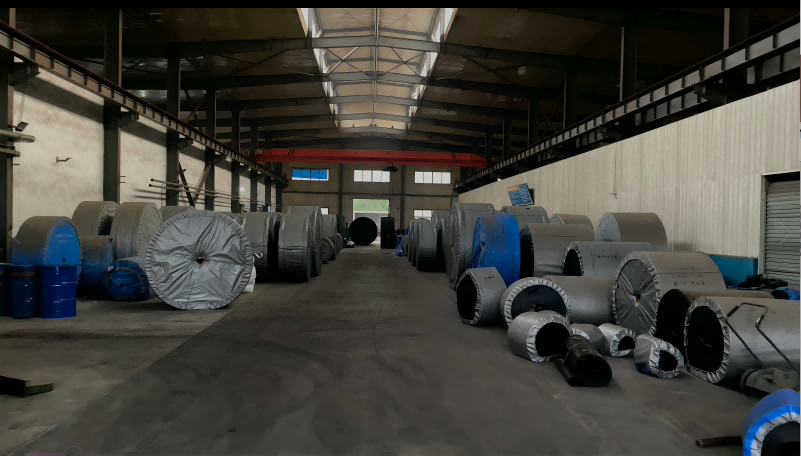 Finished conveyor belt rolls in factory warehouse